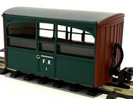 Detailed model of Festiniog Railway open sided 'Bug Box' observation coach number 1 as running during the Colonel Stephens management era finished in plain green livery.These small 4-wheel coaches are typical of early Victorian era design with the wheels hidden behind the internal seating to maintain a low centre of gravity. Many narrow gauge lines ran through isolated and scenic valleys which were inaccessible to large standard gauge trains, so open sided coaches were popular with Victorian tourists keen to view the scenery and breath in the pure mountain air.